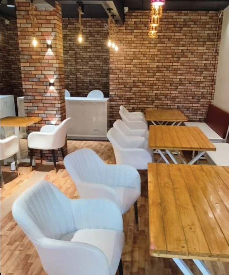 XTO Pizza dining area with brick walls and warm lights